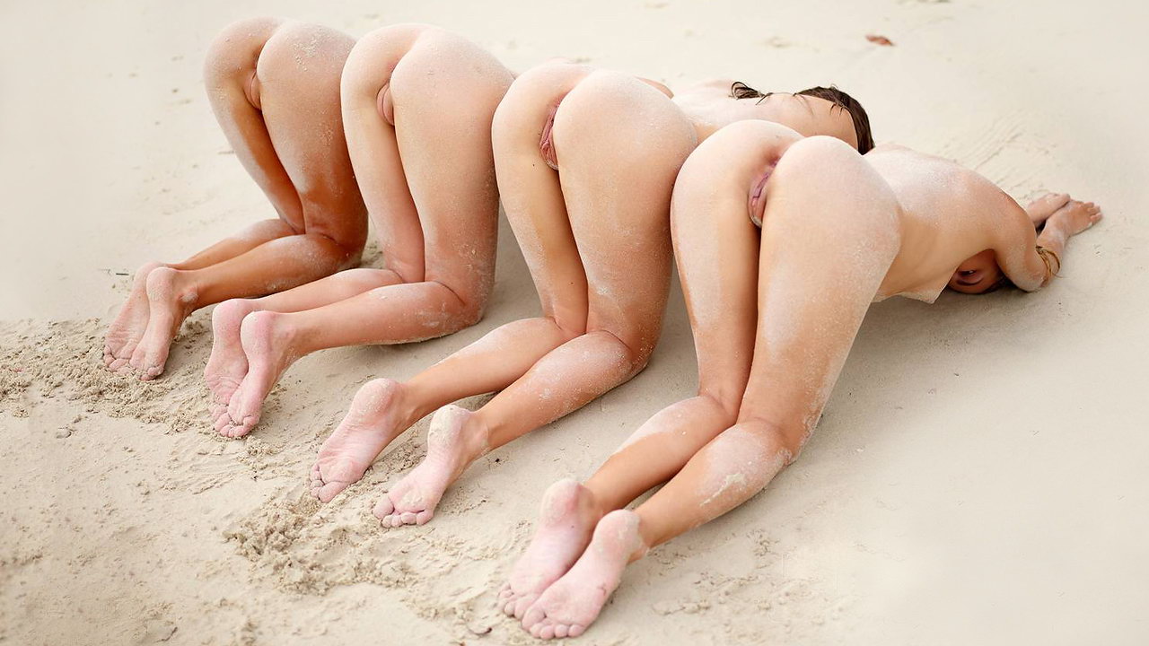 Four beautiful teen models enjoy being naked at the beach