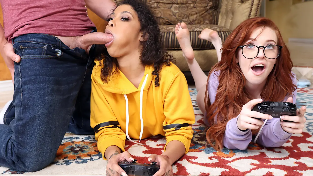 Young gamer girls have fun sharing a stiff joystick